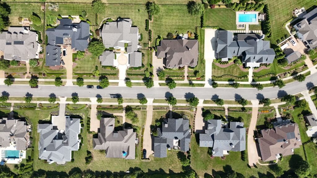 September 2026 Market Update Overhead shot of beautiful homes in a suburban Tennessee neighborhood, showcasing lush greenery and modern architecture.
